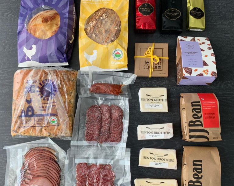 Granville Island goods laid out, including coffee, cheese, toffee, lemon squares, tea, charcuterie and bread