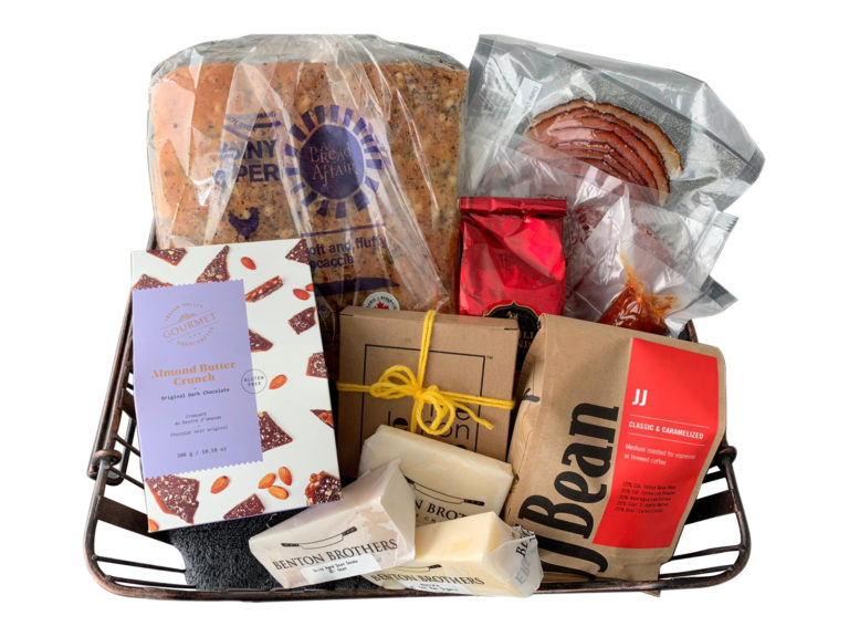 Basket full of Granville Island goods, including coffee, cheese, toffee, lemon squares, tea, charcuterie and bread