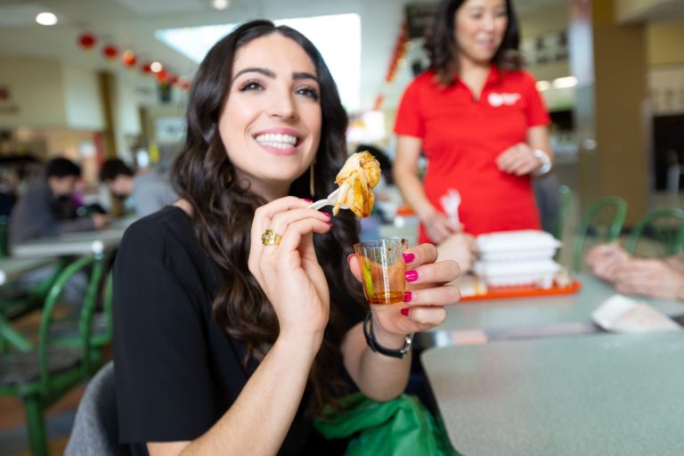 Guests smiling and showing off chili dumpling