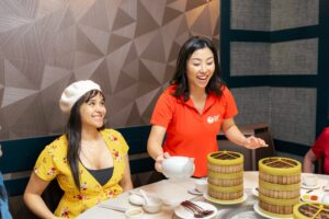 A guide in red generating happiness at one of the Authentic Asian Eats Tour