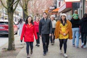 A foodie tour guide in red leading her group around the city