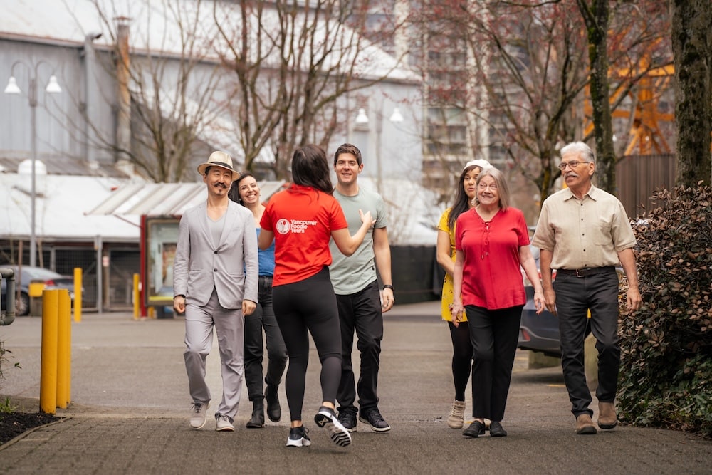 a Vancouver Foodie Tours guide leading a group of coworkers on their exploration of local cuisine