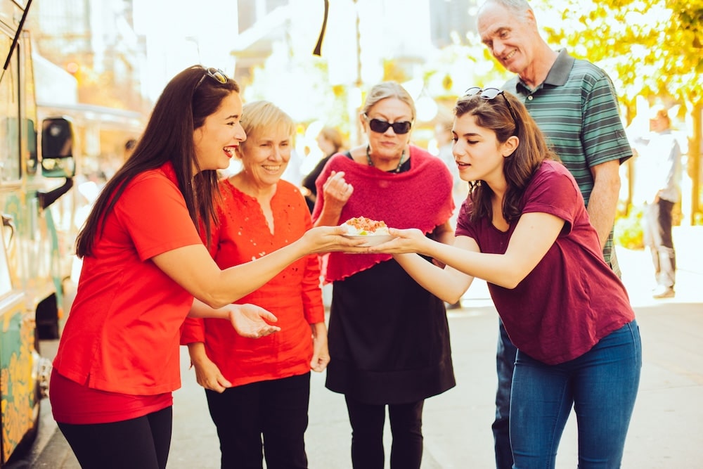 a team of coworkers connecting together while eating from the same plate 