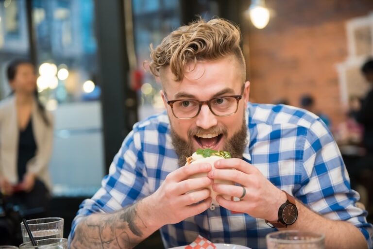 One of the best things to do in Vancouver is definitely to enjoy its diverse and delicious cuisine - just like the man on this picture, holding a sandwich, with his mouth open, ready to take a bite