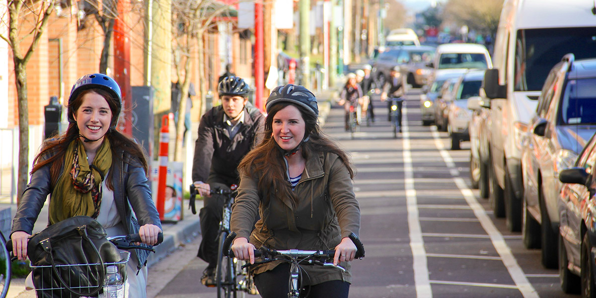 Two persons biking along the scenic Seawall near Granville Island