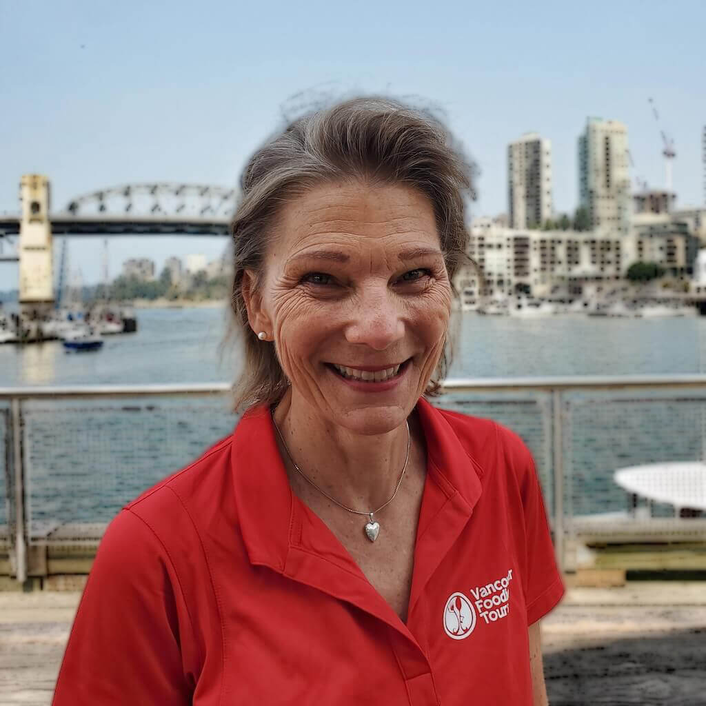 The profile picture of a Vancouver Foodie Tours guide Sandra standing on the Granville Island.