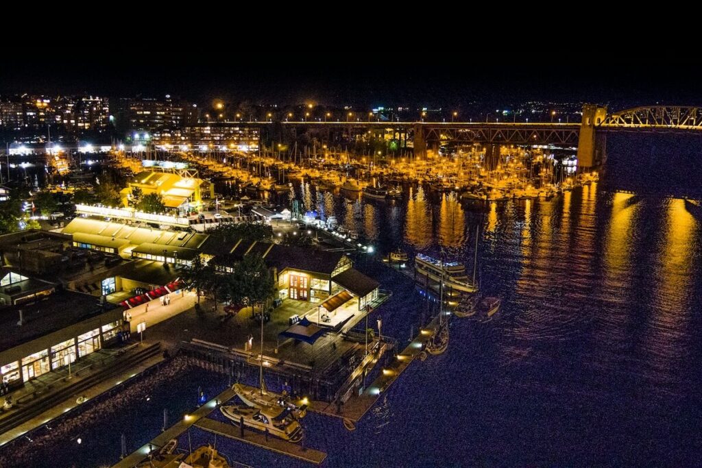 Night view of Granville Island marina and waterfront lights in Vancouver.