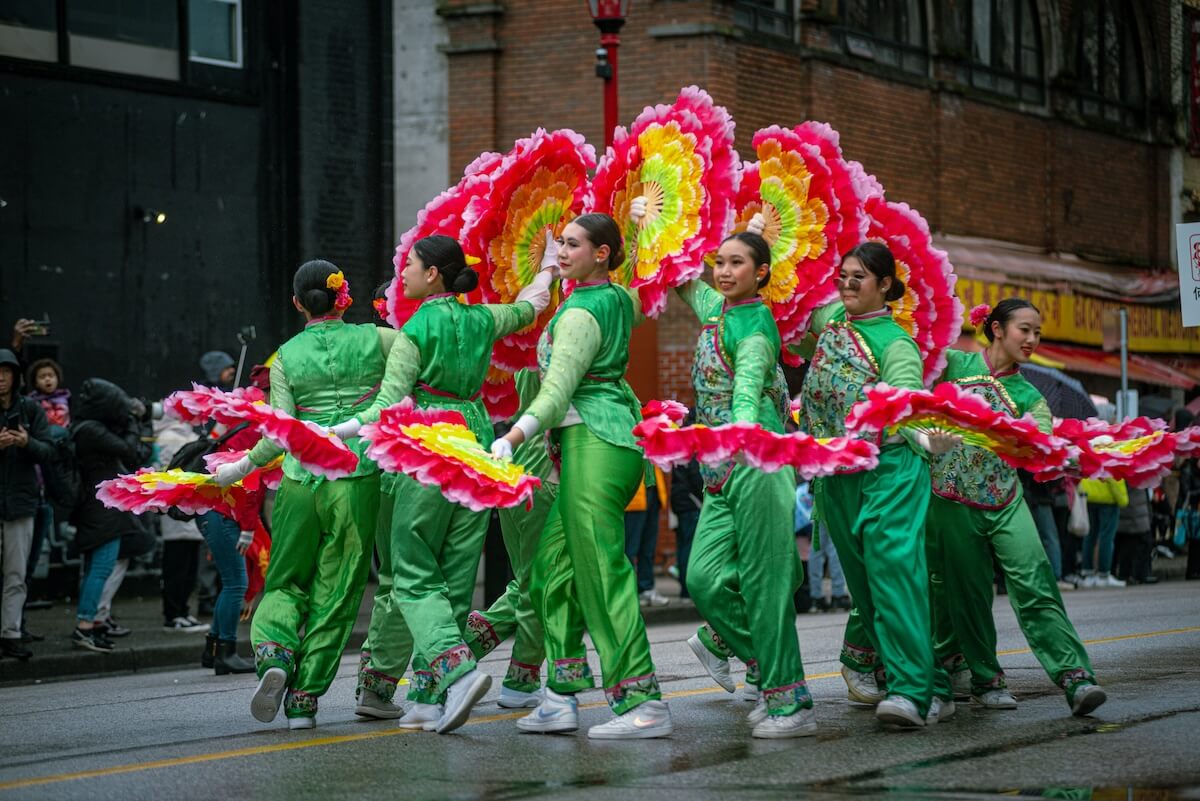Dancers with colorful flower fans perform at Vancouver’s Lunar New Year parade